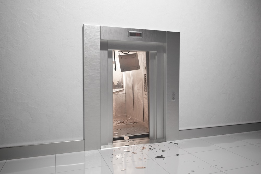 Elevator with a damaged interior panel and debris scattered on the floor after a mechanical failure