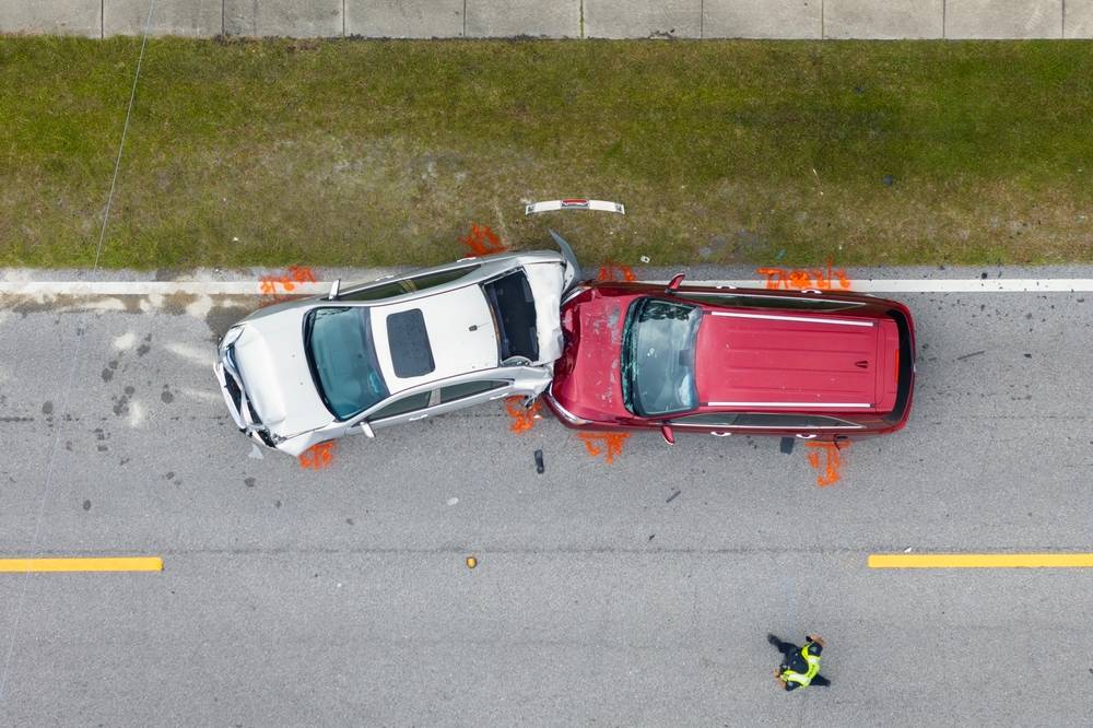 Aerial view of a two-vehicle car accident on a New Jersey roadway with debris and evidence markers