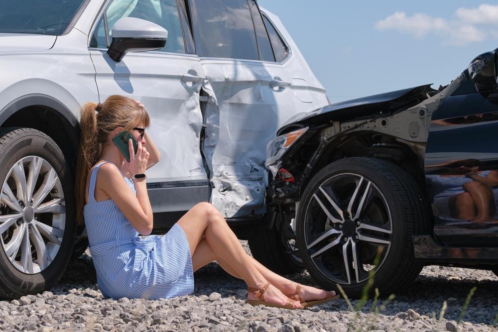 Driver calling her insurance company after a New Jersey car accident involving PIP coverage