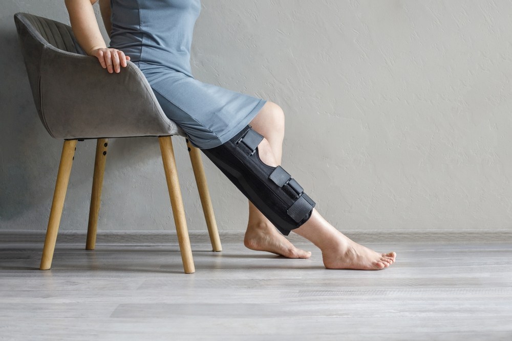 Injured client wearing a leg brace while pursuing a personal injury claim in New Jersey