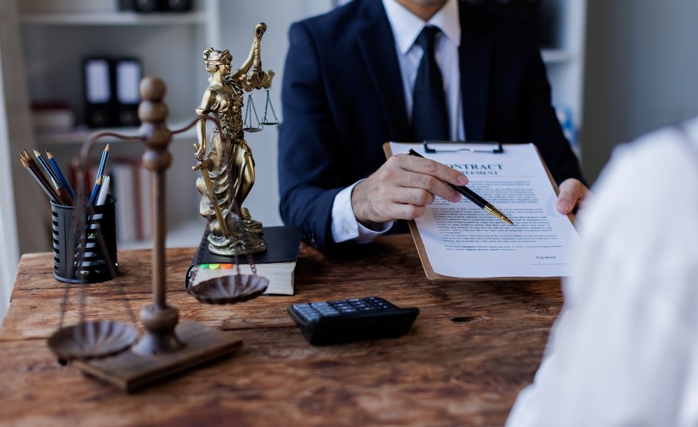 New Jersey personal injury lawyer reviewing a contingency fee agreement with a client